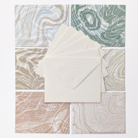 Backside of Coastal Hues set of 6 notecards with matching envelopes, embossed with Cedar Y Sand insignia.