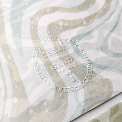 Close-up of Cedar Y Sand embossed insignia on the back of a marbled Hosho notecard.