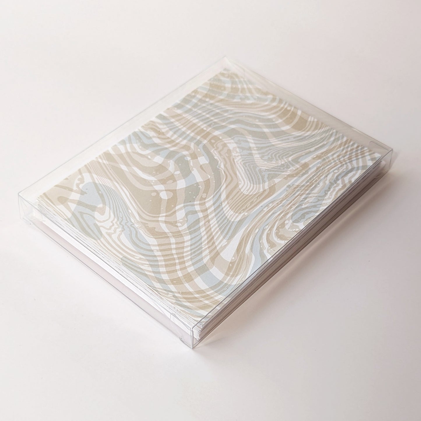Boxed Double Suminagashi Notecard Set of 6, packaged in a clear case, featuring hand-marbled coastal-inspired designs.