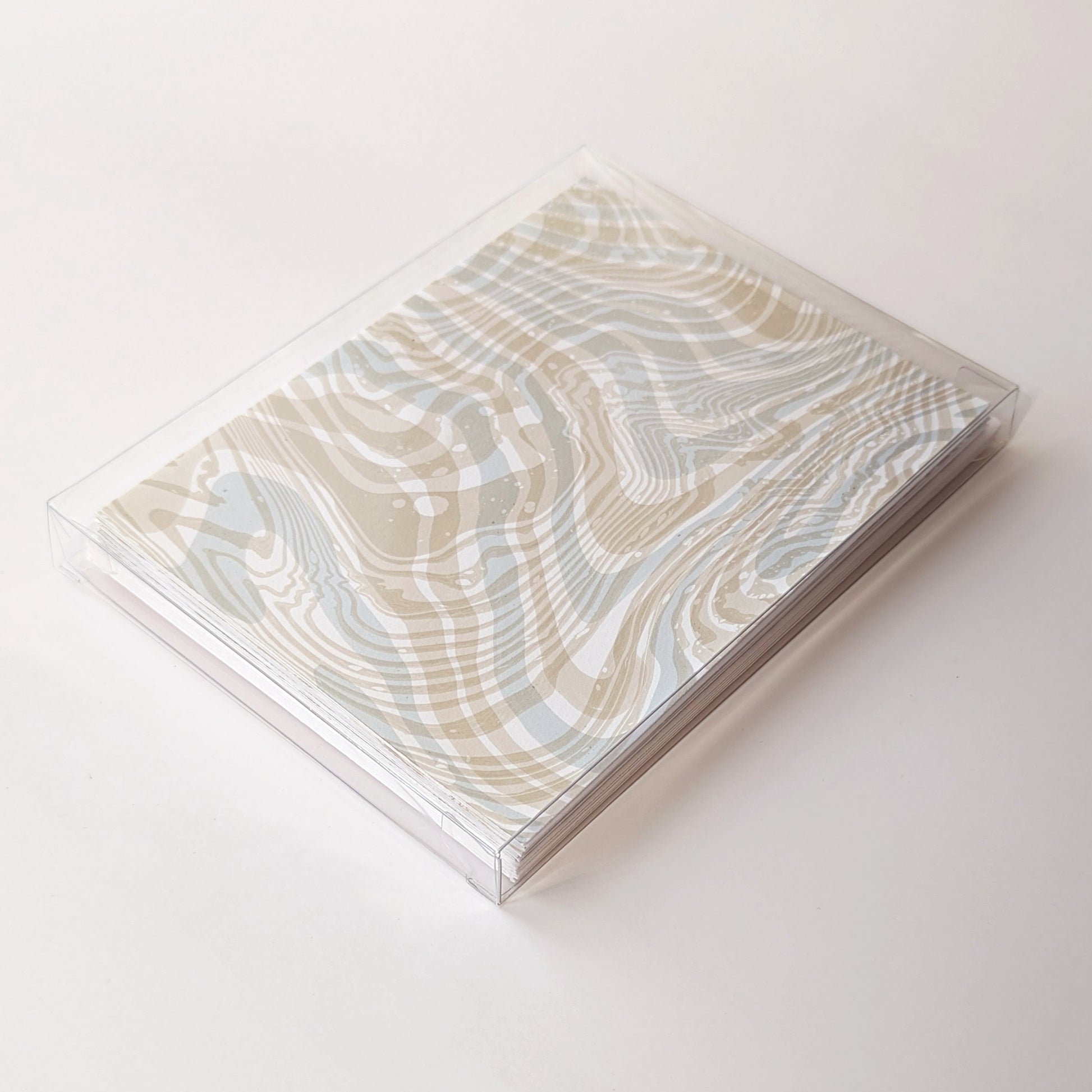 Boxed Double Suminagashi Notecard Set of 6, packaged in a clear case, featuring hand-marbled coastal-inspired designs.